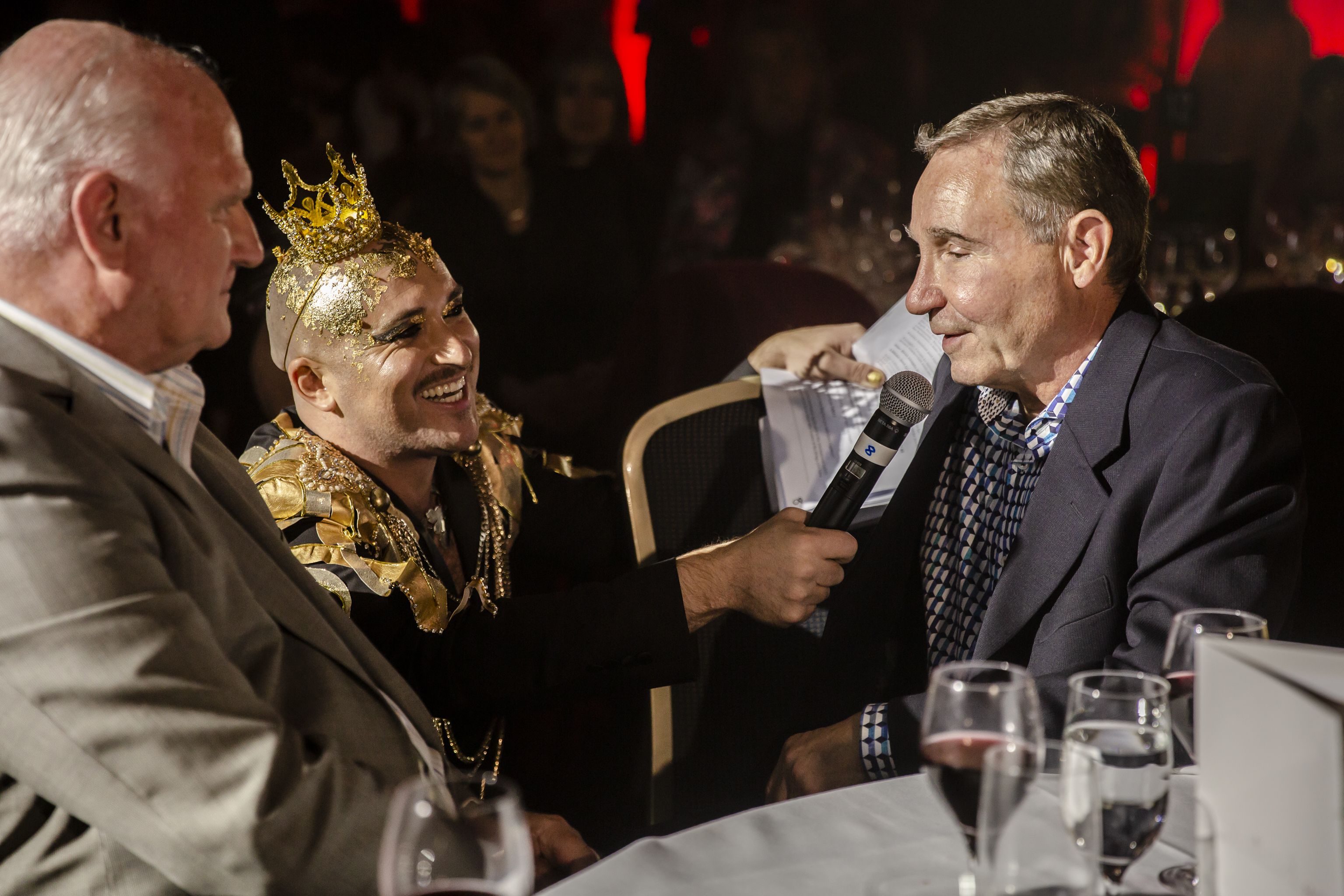 Tristan Meecham holding up a microphone to a guest