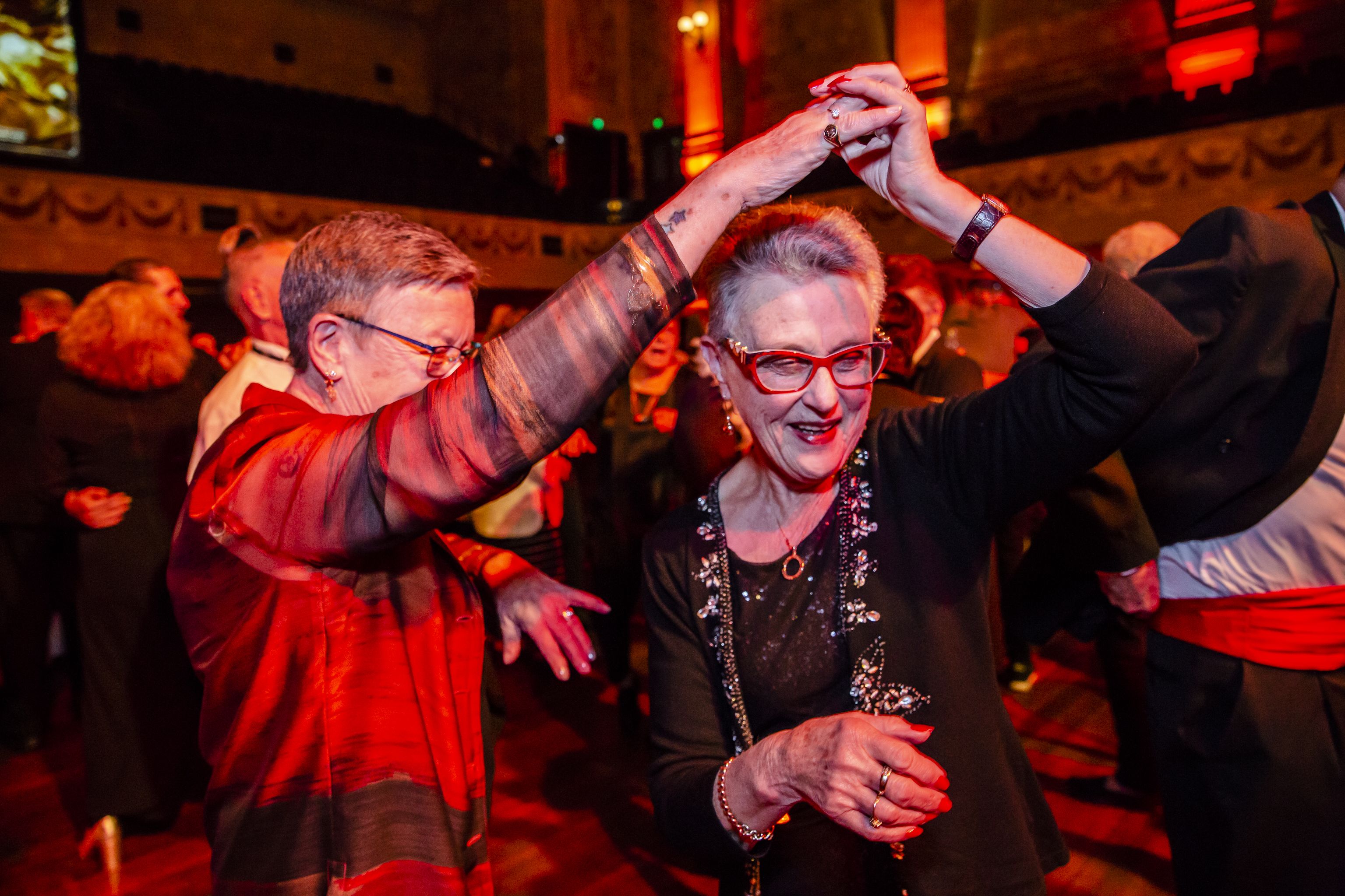 Two older women dancing with each other at The Coming Back Out Ball