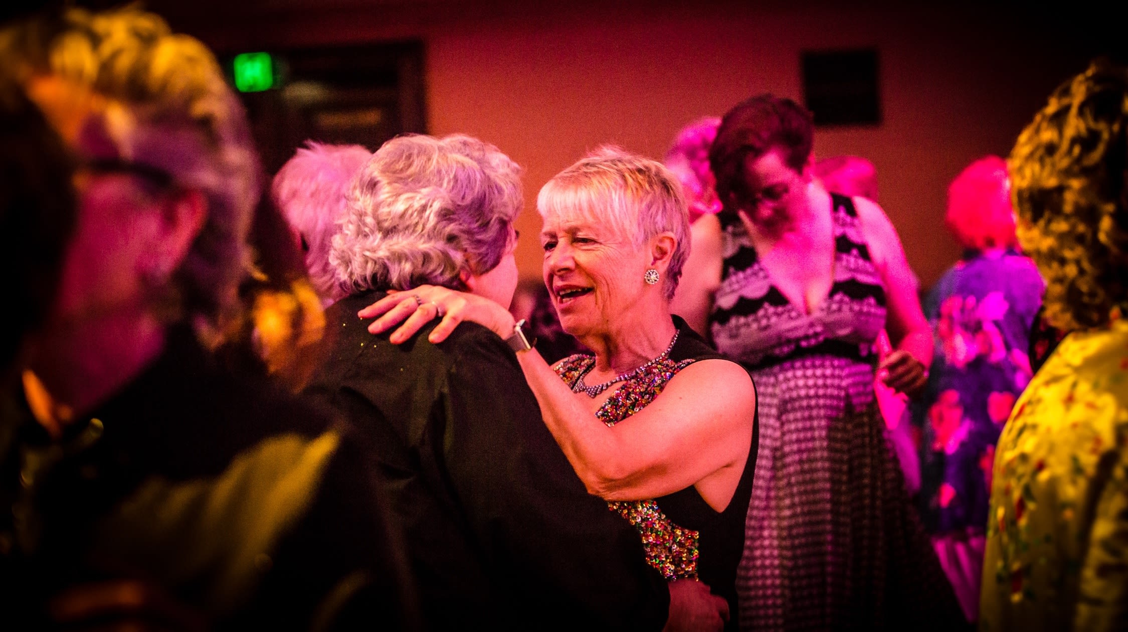 Two older women dancing with each other at the Coming Back Out Ball