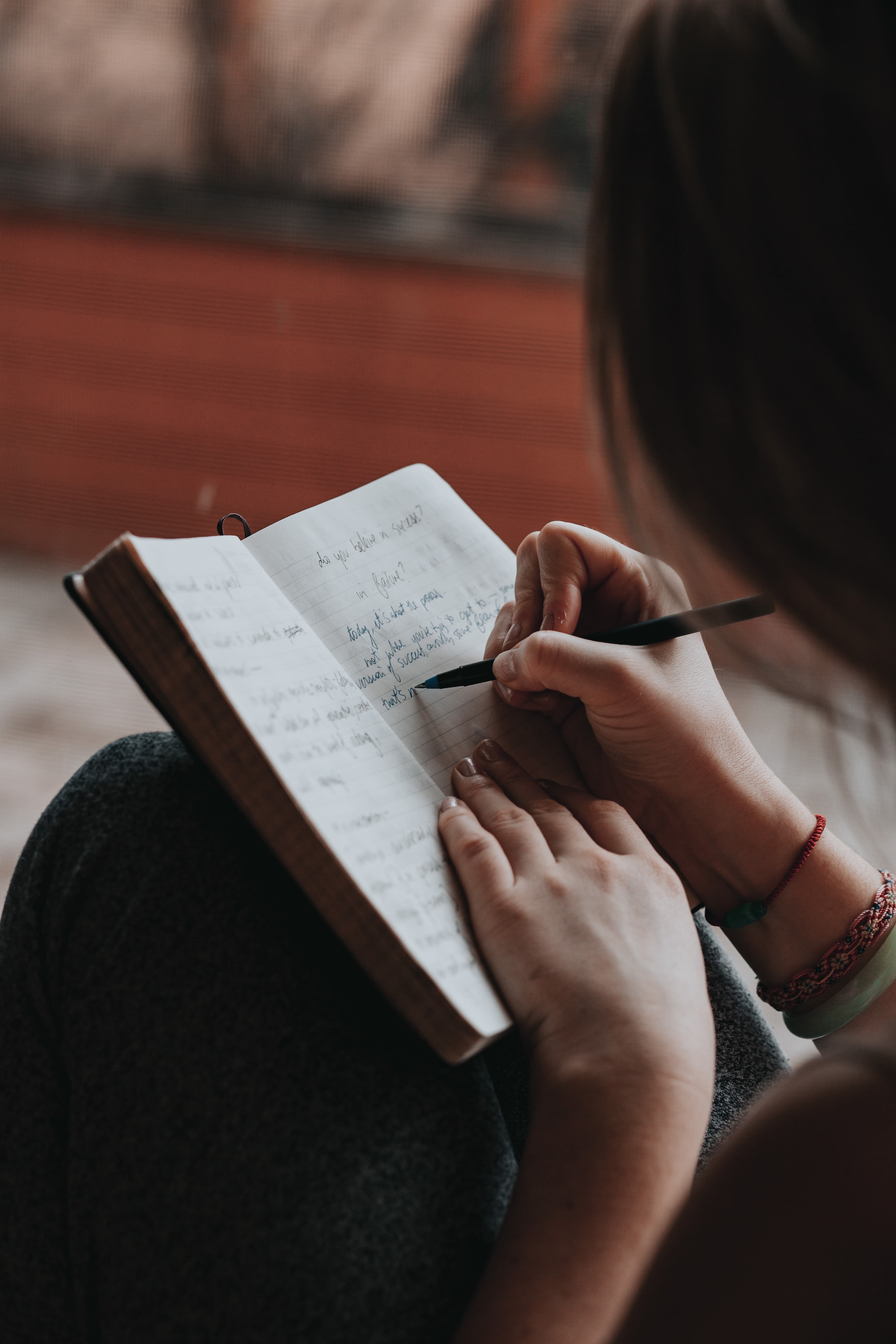 A person writing in a book