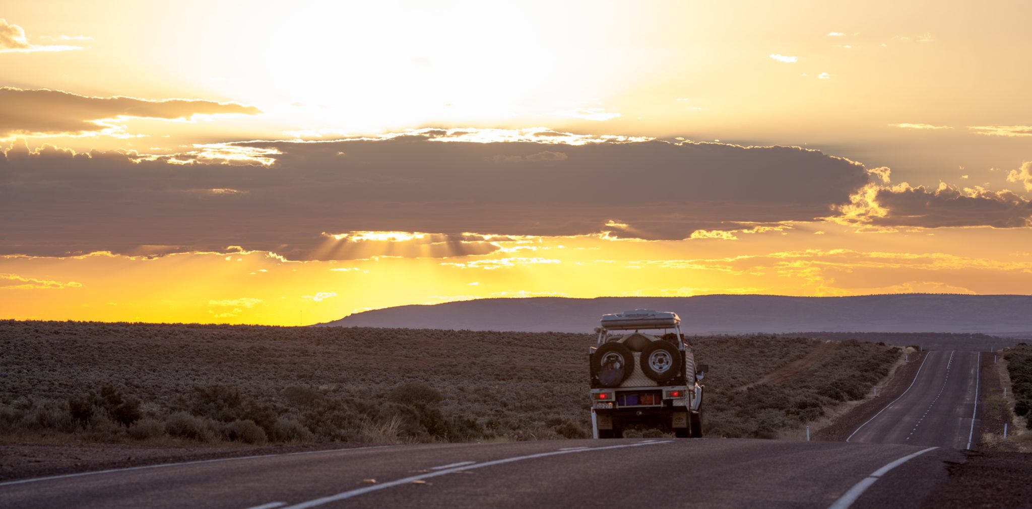 A vehicle driving on an empty regional road