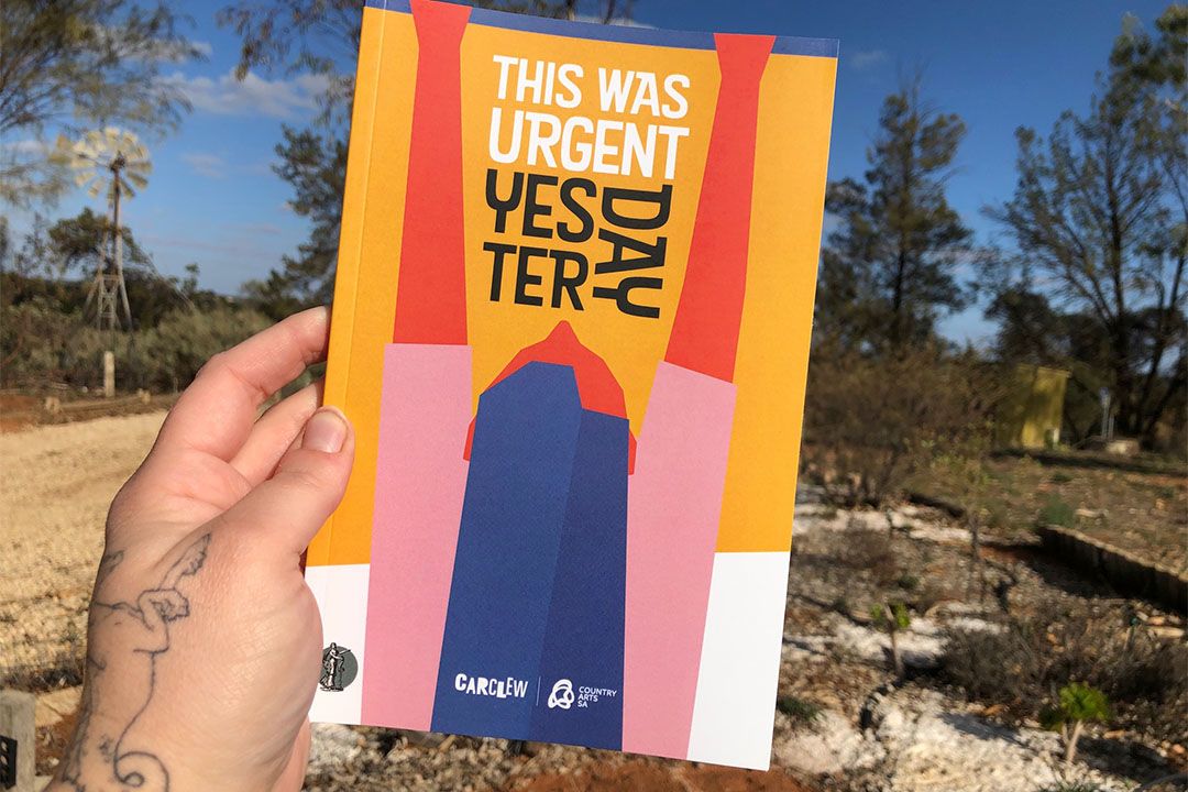 Someone holding the book 'This Was Urgent Yesterday'